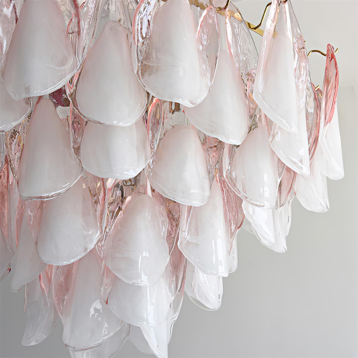 Clérachic close-up of blush pink glass petals layered thick, brass hooks visible at the top edge.