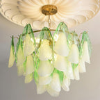 The Clérachic chandelier in sage green glass petals, close lifestyle view under a white ceiling medallion.