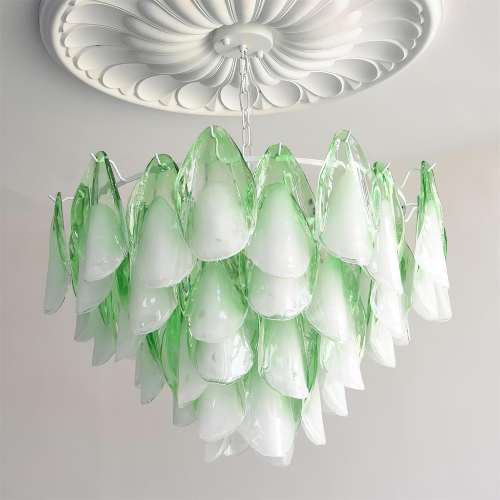 Clérachic chandelier in sage green glass petals lit beneath a white ceiling medallion, tiers cascading.
