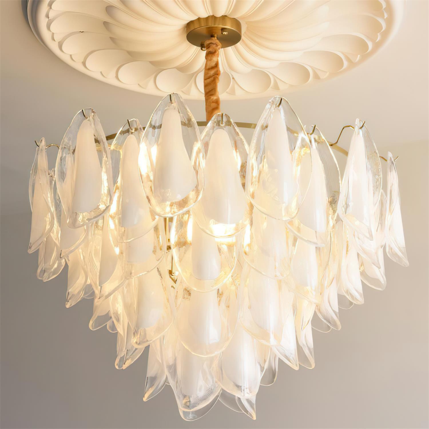 The Clérachic chandelier in clear glass petals, no colour tint, lit on a twisted rod indoors.