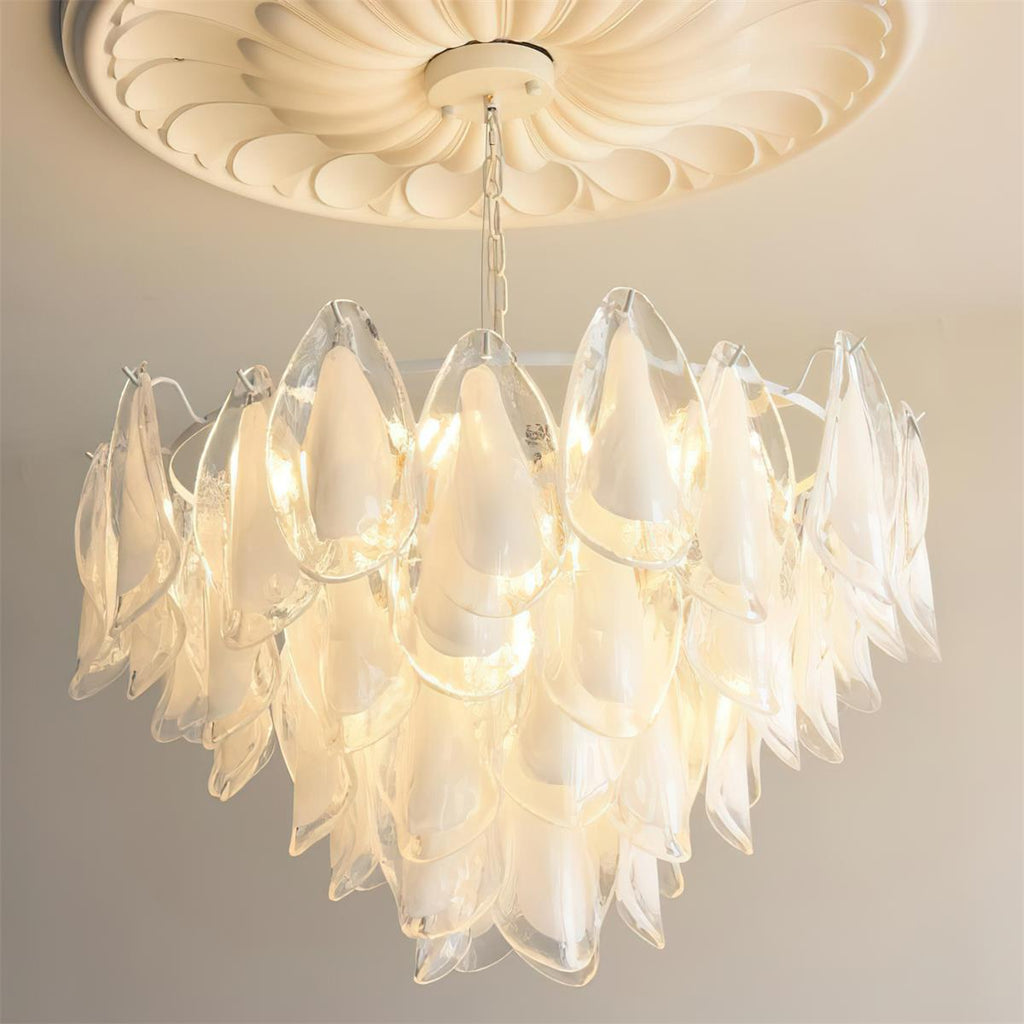 Clérachic chandelier in clear glass petals, no colour tint, lit on a brass chain in a lifestyle setting.