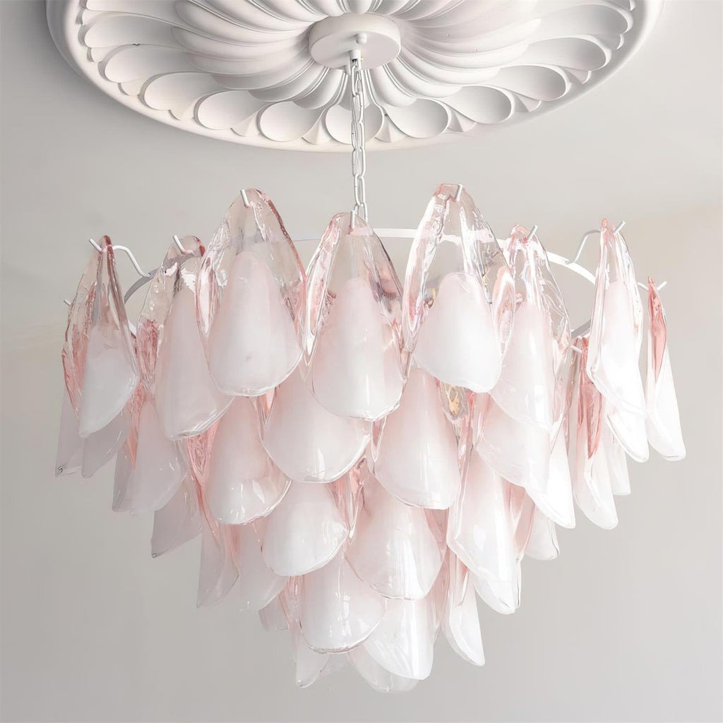 The Clérachic chandelier in blush pink glass petals lit beneath a white ceiling medallion.