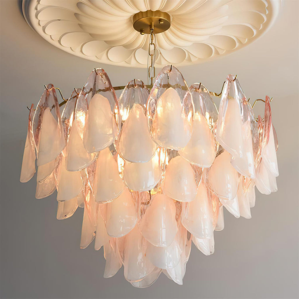 Clérachic close lifestyle view of blush pink glass petals lit warmly under a ceiling medallion.