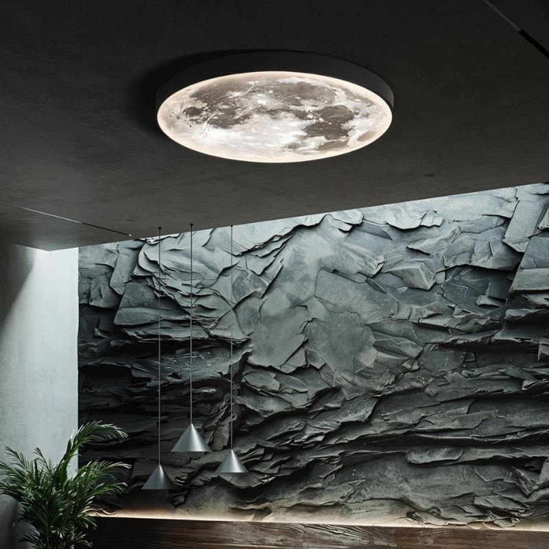 Clérachic black-rimmed moon ceiling light glowing against a dark ceiling, with a textured slate wall and pendant lights below.