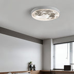 Clérachic white-rimmed moon ceiling light lit in a grey study with a wooden desk, laptop and window blinds.