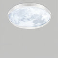 Clérachic slim white-framed ceiling light with a cool-white lunar surface pattern, seen from below on a plain grey ground.