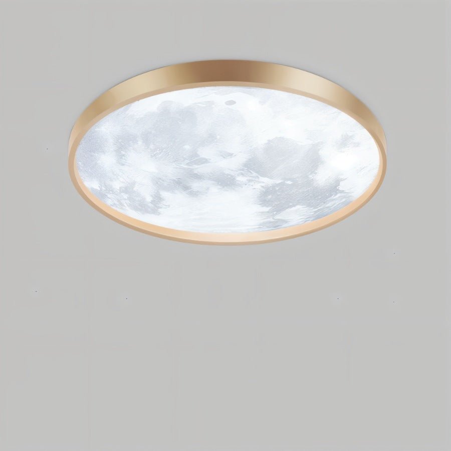 Clérachic slim gold-framed ceiling light with a cool-white lunar surface pattern, seen from below on a plain grey ground.