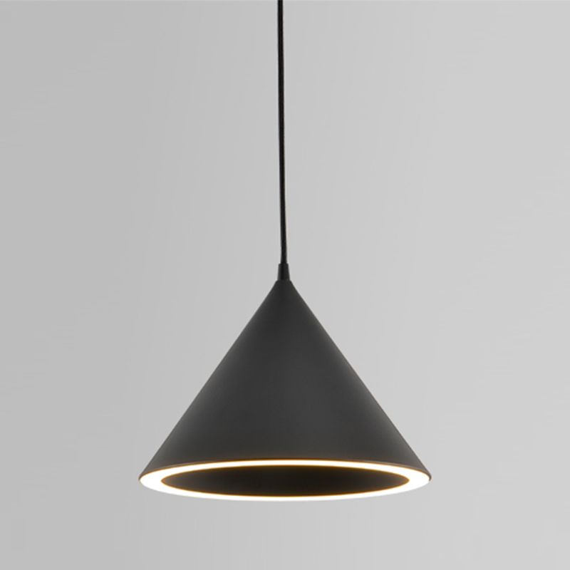 Clérachic Funnel Pendant Light in matte black against a grey wall, the acrylic diffuser ring glowing warm white around its rim.