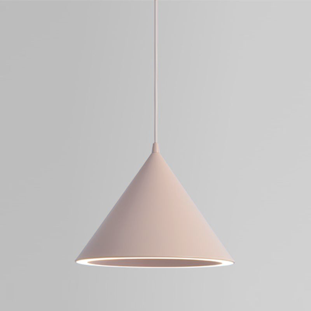 The Clérachic Funnel Pendant Light in soft pink on a matching flex, shown against a plain wall for a clear look at the cone.