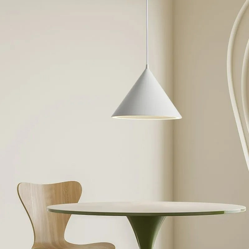 The Clérachic Funnel Pendant Light in white above a small round dining table, dropping a clean pool of light onto the top.
