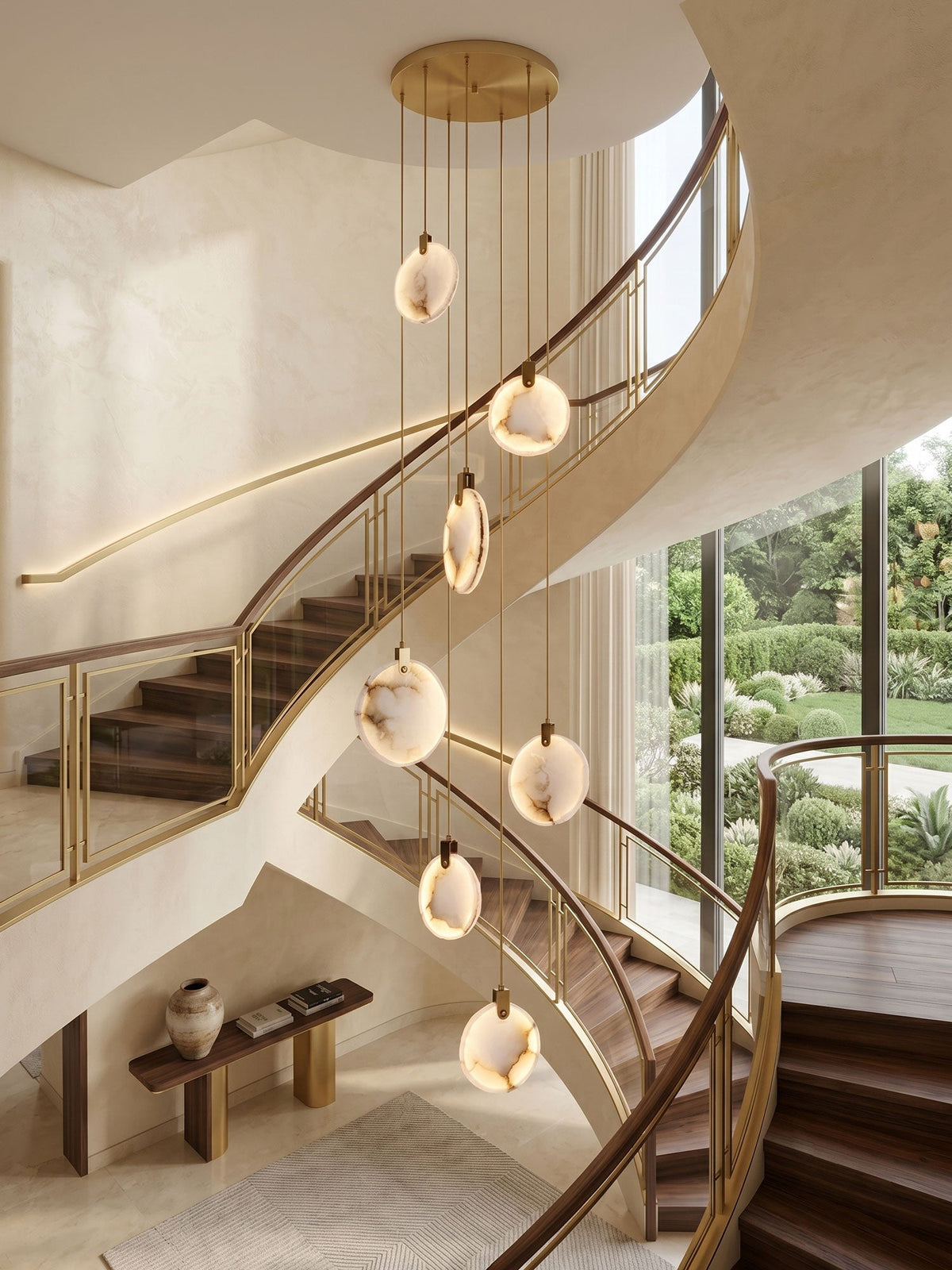 Lit alabaster disc pendants from Clérachic fall past a sweeping cream staircase with timber treads and a garden view.
