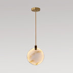 A single Clérachic alabaster disc pendant on a short brass rod and a small gold ceiling plate, on a grey backdrop.