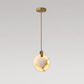 Clérachic alabaster disc pendant on a long brass rod with a gold ceiling plate, lit warm and shown on a grey backdrop.