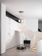 A high view of the Clérachic cluster with lit alabaster discs, in a white hall with a curved stair and glowing steps.