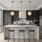 Three Clérachic alabaster disc pendants hang in a row above a marble island and wooden stools in a dark grey kitchen.