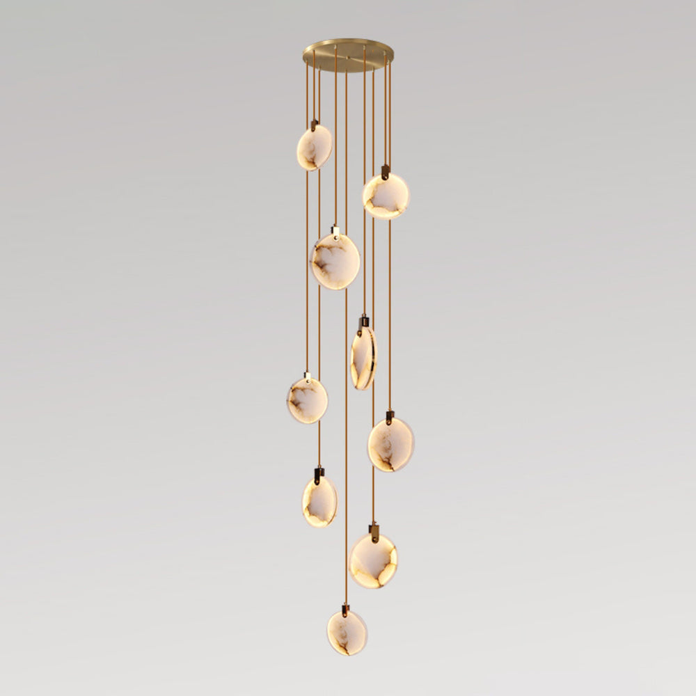 Clérachic alabaster disc pendants on tan cords of differing lengths from a gold canopy, forming a tall narrow cluster on grey.
