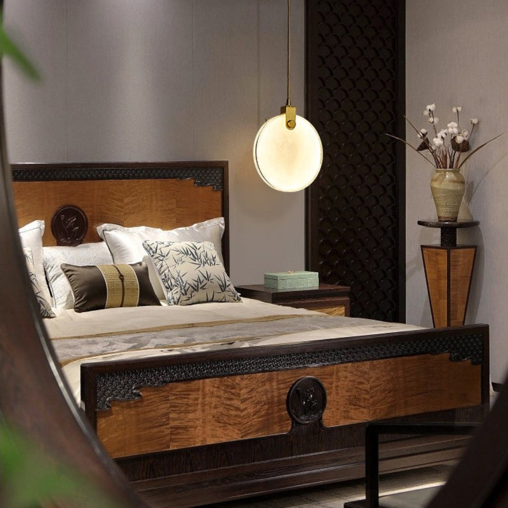 A single Clérachic alabaster disc pendant glows above a carved timber bed in a bedroom with dark lattice panelling.