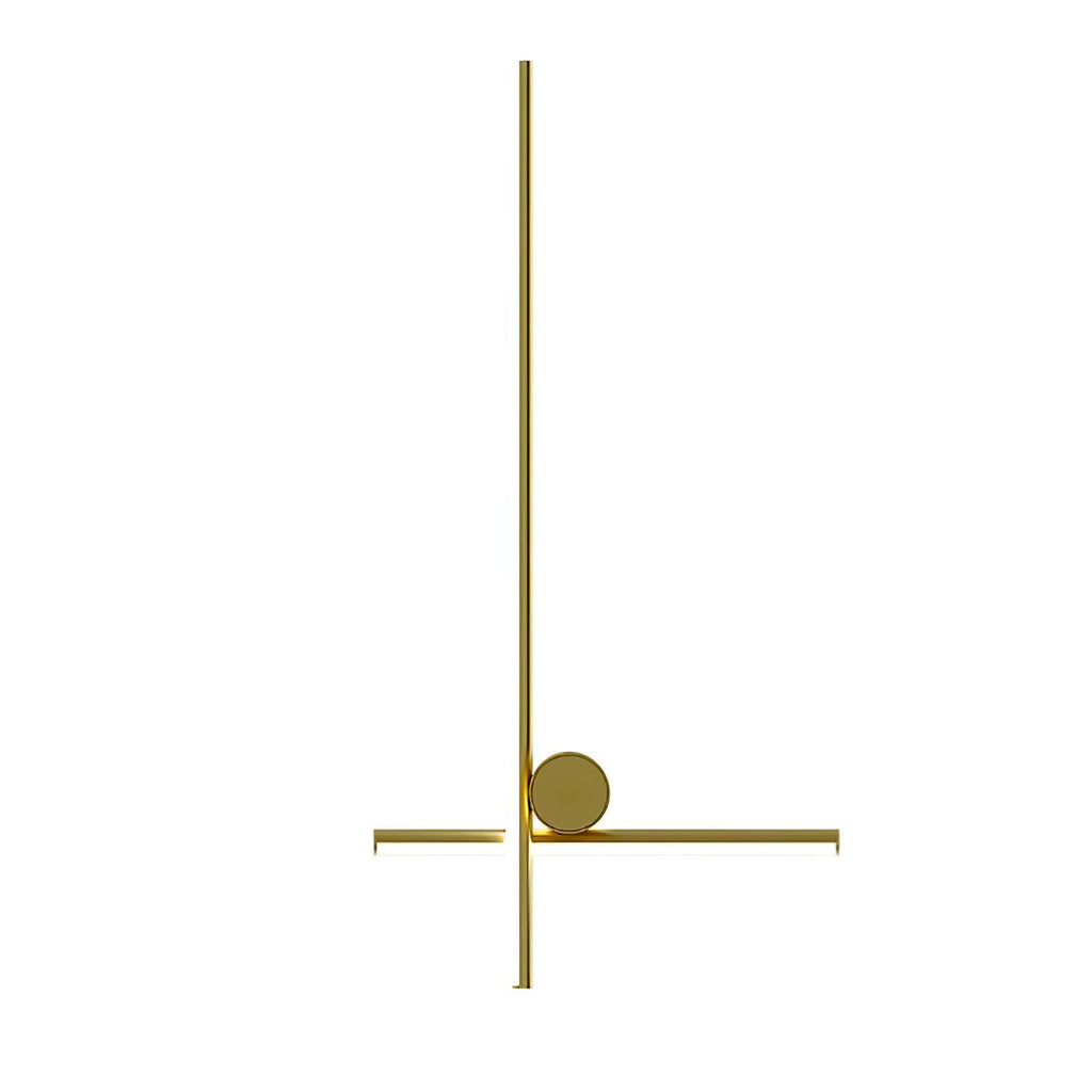 Gold Clérachic wall light with a long vertical bar crossed near the bottom by a short bar and a disc, on a plain white backdrop.