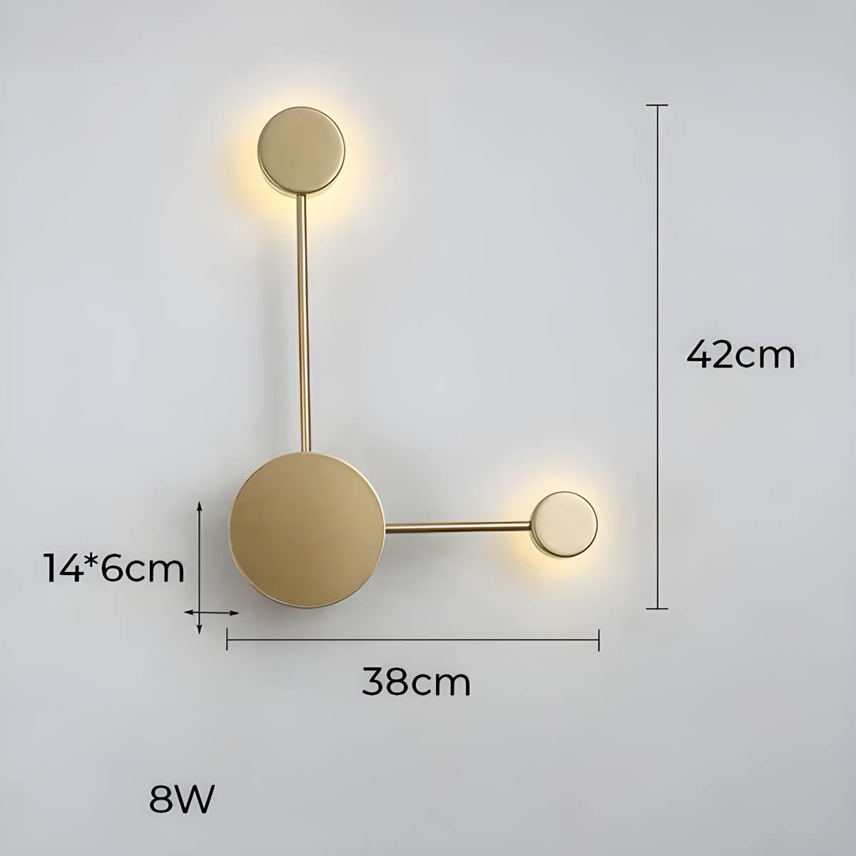 Clérachic two-light geometric wall light in gold, a dimension drawing of the round plate and its two glowing discs against a pale grey wall, 42 cm tall by 38 cm wide.