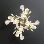The Clérachic gingko sconce face-on, gold stems radiating outward with white petal shades at every tip.