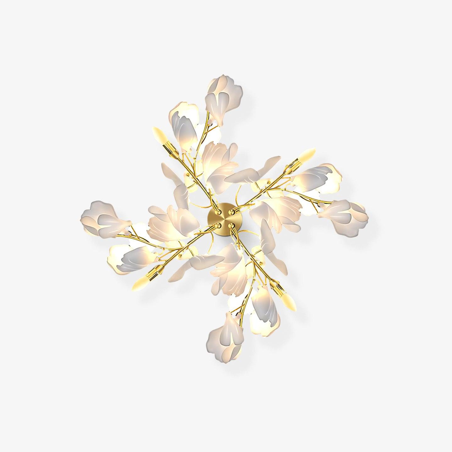 Clérachic gingko wall light on a pale wall, gold branches and white ceramic leaves opened like a bloom.