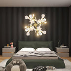 Clérachic gingko wall light glowing above a bed in a green panelled bedroom.