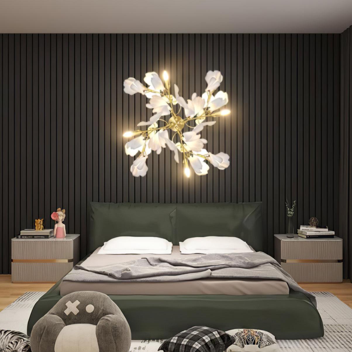 Clérachic gingko wall light glowing above a bed in a green panelled bedroom.