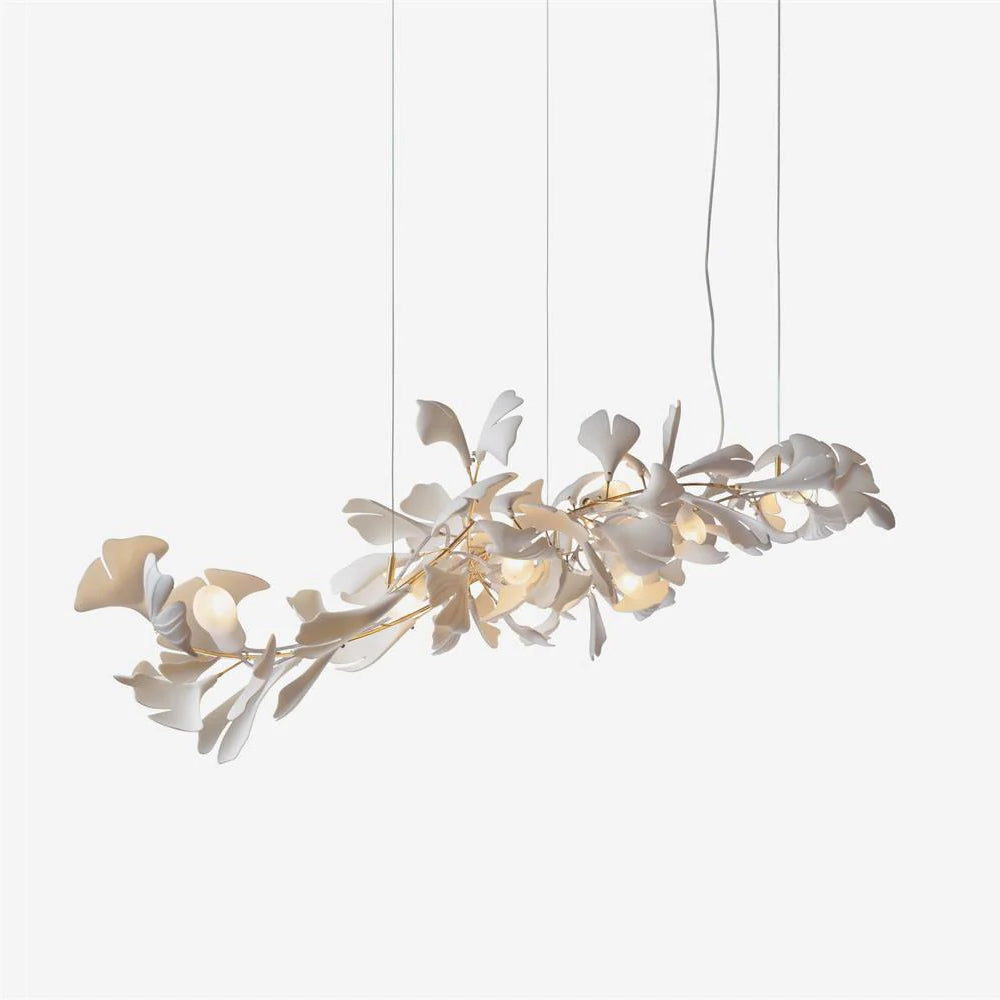 Clérachic gingko chandelier on pale grey, its leaves layered along a wide gold stem.