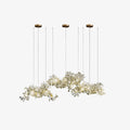 Clérachic gingko cluster chandelier on white, several leaf sprays hung at staggered heights.