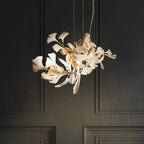 The Clérachic gingko chandelier lit against dark panelled doors, its leaves glowing warm.