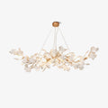Clérachic gingko chandelier on white, gold arms fanning out under a round canopy with white leaves.