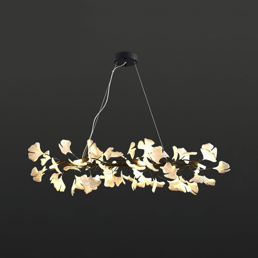 The Clérachic gingko ring chandelier with a black frame, ceramic leaves lit around the circle.