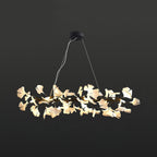 The Clérachic gingko ring chandelier with a black frame, ceramic leaves lit around the circle.
