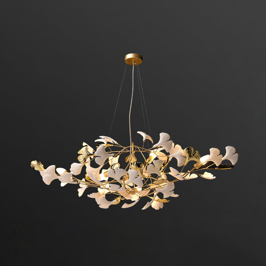 Clérachic gingko chandelier on a charcoal background, gold branches spreading wide with white ceramic leaves.