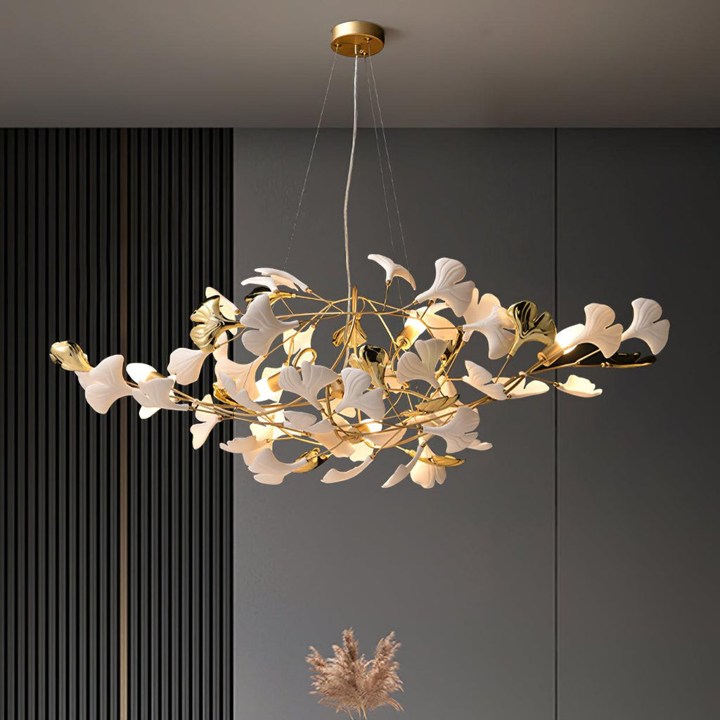 The Clérachic gingko chandelier lit in a room with dark slatted panelling and grey walls.