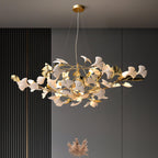 The Clérachic gingko chandelier lit in a room with dark slatted panelling and grey walls.