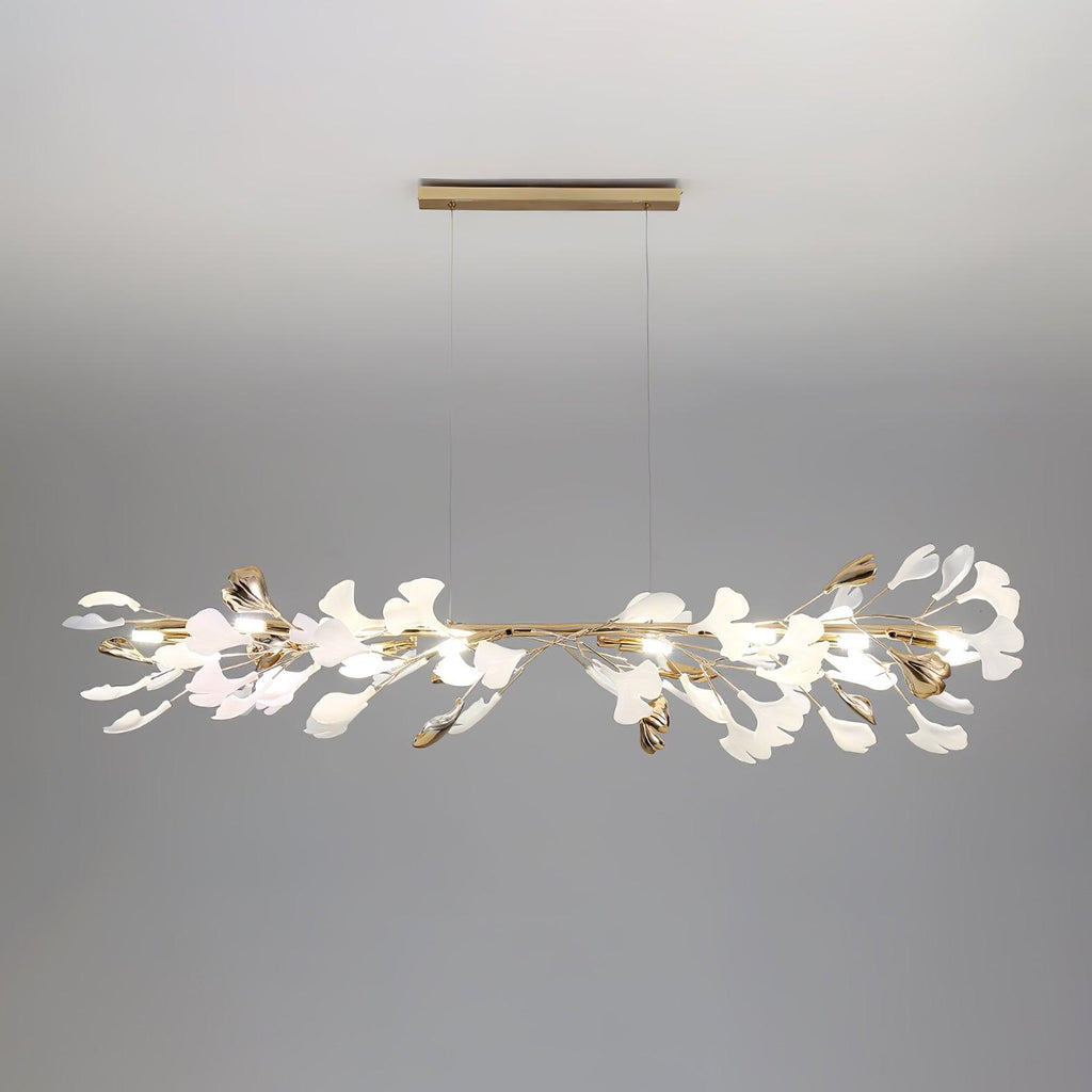 The linear Clérachic gingko chandelier on grey, hung from a slim brass ceiling bar.