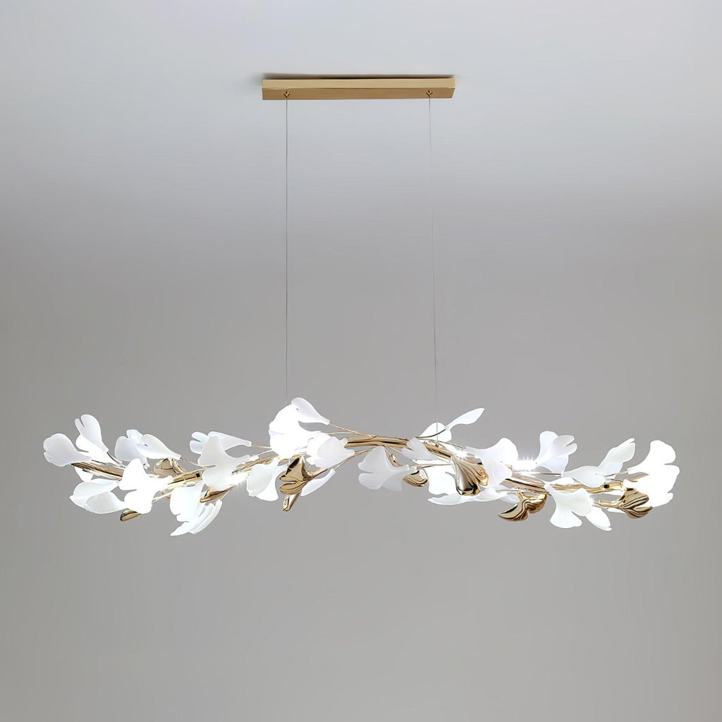 Clérachic linear gingko chandelier seen wider, its leaves spread along the full brass bar.