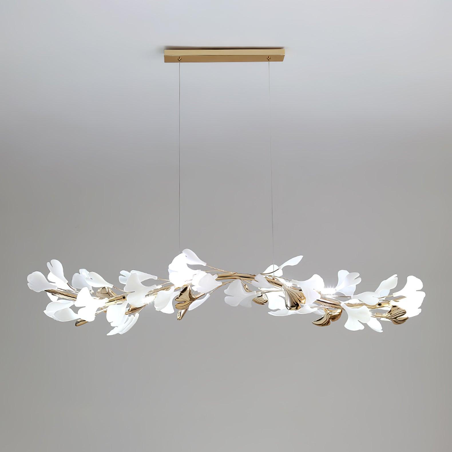Clérachic linear gingko chandelier seen wider, its leaves spread along the full brass bar.