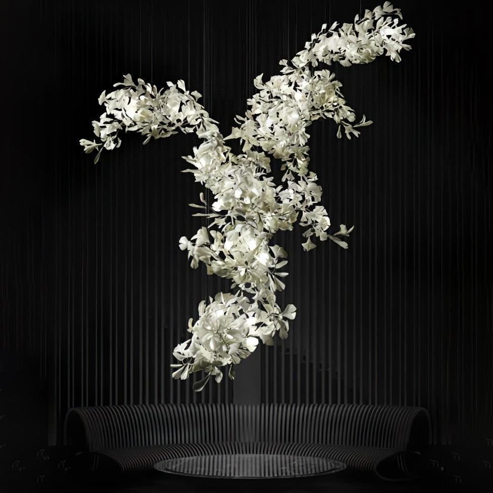 Clérachic gingko chandelier against black, porcelain leaves massed along a branching frame.