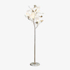 The Clérachic gingko floor lamp with a pale marble base, white leaves gathered like a small tree.