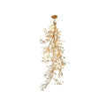 Clérachic gingko branch chandelier on white, a long cascade of ceramic leaves down a gold stem.