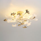 Clérachic gingko ceiling light lit on a pale ceiling, gold leaves mixed among white ceramic ones.
