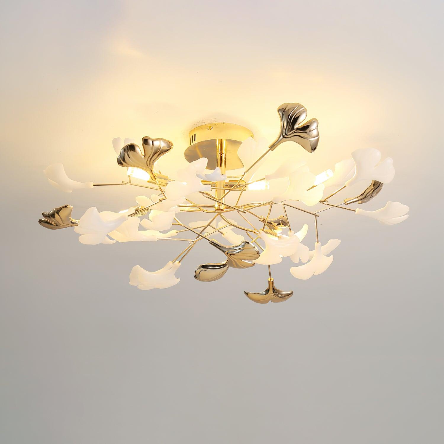 Clérachic gingko ceiling light lit on a pale ceiling, gold leaves mixed among white ceramic ones.