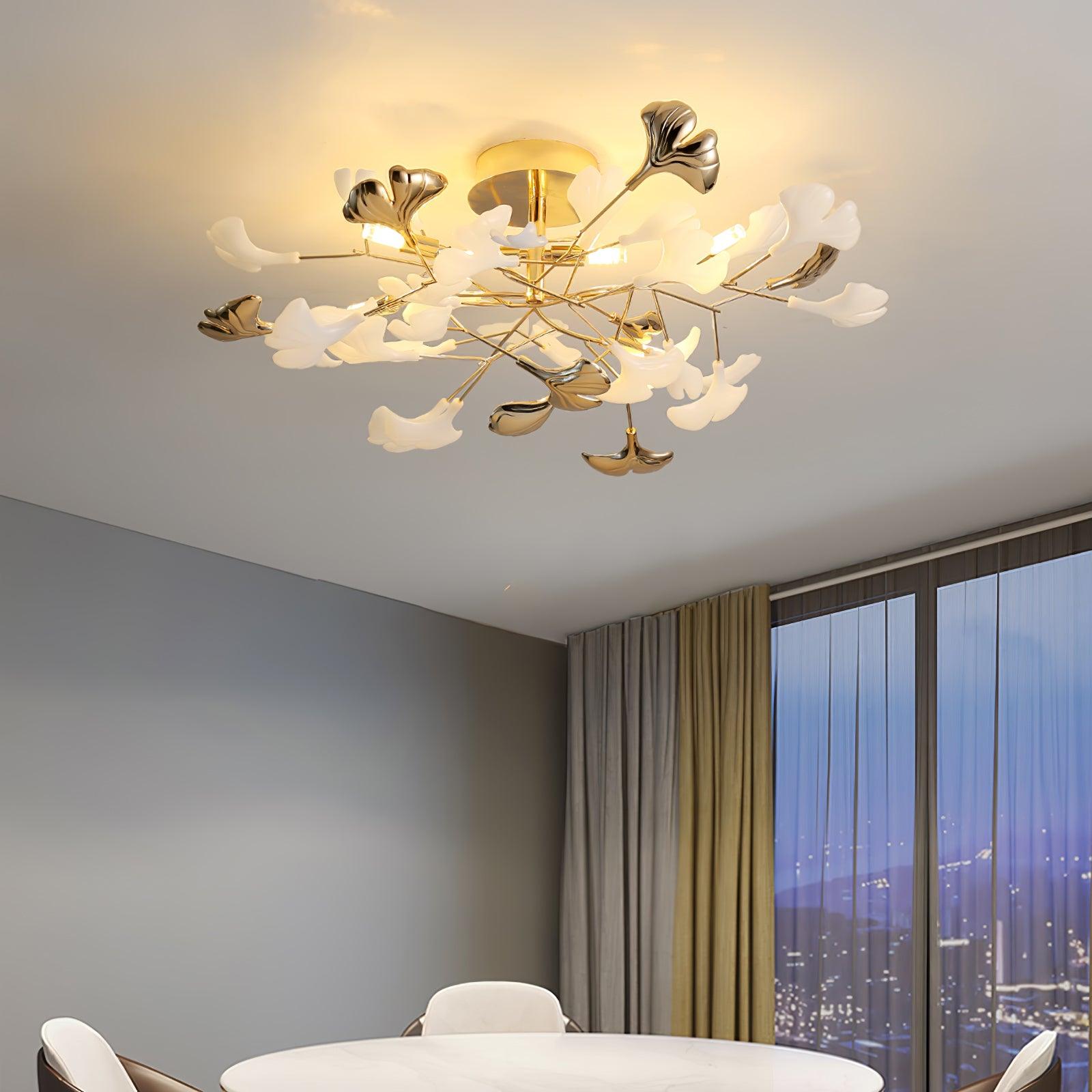 Clérachic gingko ceiling light lit above a dining table beside floor-to-ceiling windows at dusk.