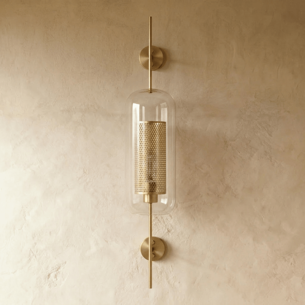 Clérachic wall lamp's capsule shade shown head-on, with the two round brass wall plates visible above and below the glass.