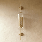 Clérachic wall lamp's capsule shade shown head-on, with the two round brass wall plates visible above and below the glass.
