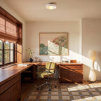 Clérachic white glass disc ceiling light with an opal globe bulb in a warm walnut home office with a green chair.