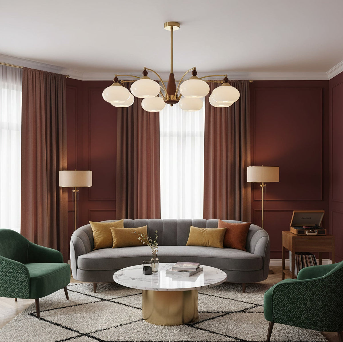 A Clérachic chandelier with white glass shades hangs in a living room with brick-red curtains, a grey curved sofa and a round marble table.