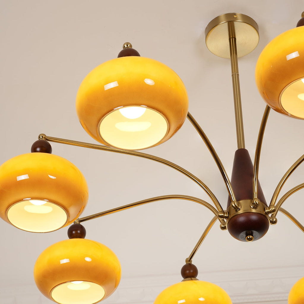 Looking up at the gold ceiling plate and caramel glass shades, lit from within, on this Clérachic chandelier.
